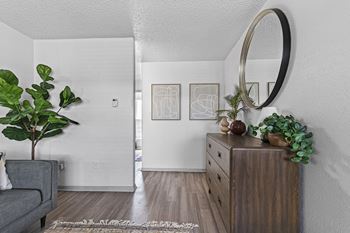 a living room with a dresser and a mirror